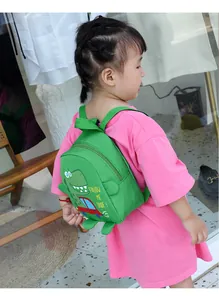 Toddler green canvas crossbody bag featuring a cute cartoon dinosaur and slogan