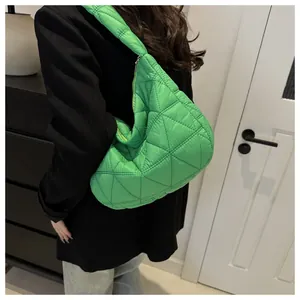 Close-up of a green quilted cloud shoulder bag in large diamond lattice nylon fabric