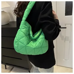 Detail view of large green quilted puffer shoulder bag with a puffy rhombus pattern