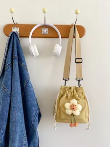 Yellow canvas bucket bag with drawstring and cute flower decor for daily use