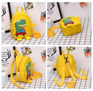 Detail view of yellow dinosaur backpack showing back straps and anti-lost safety leash