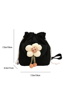 Black canvas bucket bag with floral accent and orange charms showing dimensions