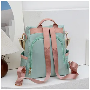 Détail arrière du sac à dos Oxford vert avec fermeture éclair antivol et bretelles roses