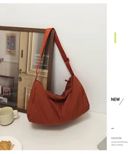 Caramel quilted nylon crossbody bag displayed in a cozy lifestyle coffee shop setting