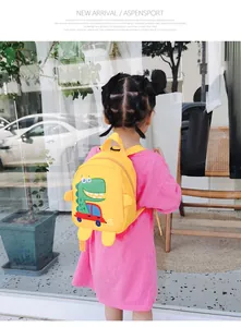 Detailed view of yellow toddler backpack with cute cartoon dinosaur and car prints