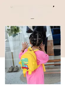 Detailed view of yellow toddler backpack with cartoon dinosaur and adjustable straps