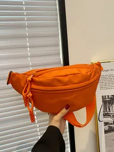 Bright orange nylon crossbody chest bag with adjustable strap and braided zipper puller