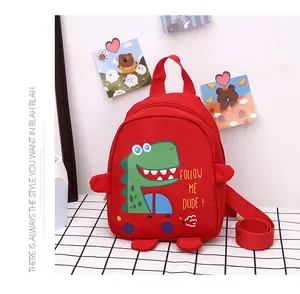 Detail of red cartoon dinosaur canvas bag with Follow Me Dude print and nylon straps