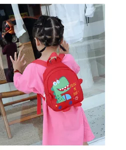 Toddler red dinosaur backpack detail with 3D spikes and Follow Me Dude text design