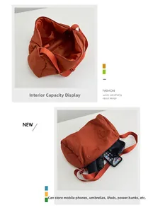 Detail view of large burnt orange nylon crossbody bag showing spacious interior capacity