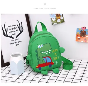 Detail of green canvas kids bag with dinosaur print and 3D decorative claws