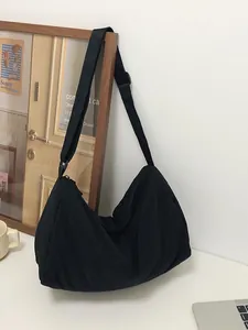 Large black nylon half-moon crossbody bag with adjustable strap and spacious interior