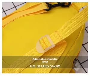 Detail of adjustable yellow strap with transparent plastic buckle on a dinosaur bag