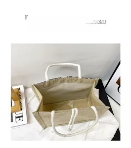 Top view of spacious beige linen tote bag with soft rope handles and a minimal design