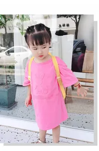 Outdoor shot of a pink cotton dress with 3D embossed rabbit design and a yellow backpack