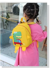 Detail of yellow toddler backpack with cartoon dinosaur and safety anti-lost leash strap