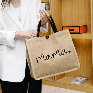 Fashionable beige jute tote bag with black mama lettering and sturdy webbed handles