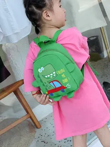 Green dinosaur canvas backpack for kids featuring cartoon prints and side 3D fins