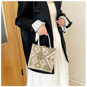 Close-up of ethnic canvas handbag featuring crochet patterns and wooden button closure