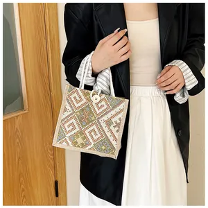 Close-up of ethnic canvas tote bag with geometric woven pattern and button closure