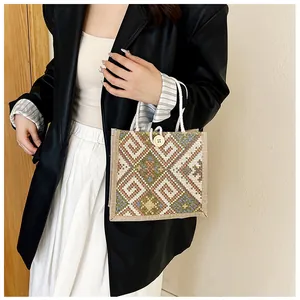 Detailed view of ethnic geometric woven canvas bag with cotton rope handles and wood button