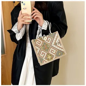 Detailed shot of ethnic woven tote with geometric patterns and cotton rope handle