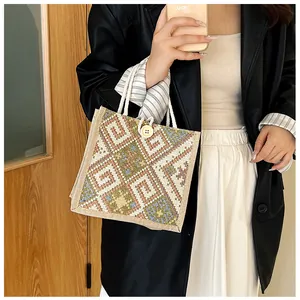 Detailed texture of geometric jacquard canvas bag with rope handle and wood button