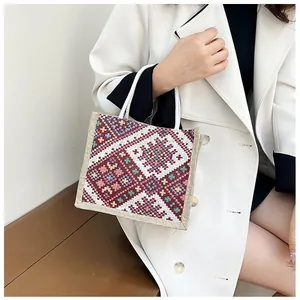 Detailed view of bohemian canvas tote bag featuring intricate floral woven patterns