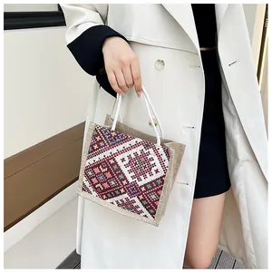 Ethnic style linen handbag featuring colorful geometric patterns and soft rope handles