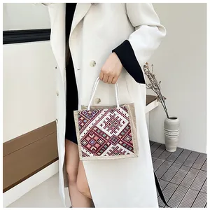 Detailed close-up of a bohemian woven jute handbag with colorful geometric patterns