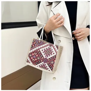 Detailed embroidery and texture on canvas handbag with ethnic geometric patterns