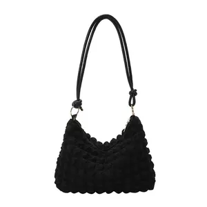 Fashionable black popcorn textured shoulder bag with soft pleated design and knot detail