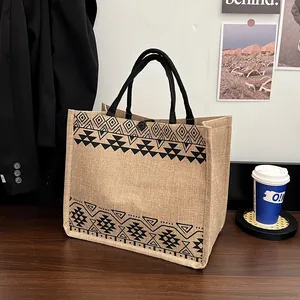 Ethnic pattern jute tote bag with black webbing handles and snap closure for women