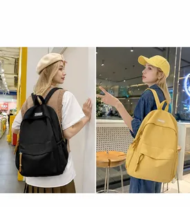Lifestyle shot showing large capacity black and yellow canvas backpacks for students