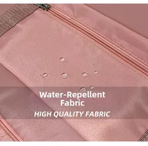 Close-up of water-repellent lotus pink fabric with droplets on folding travel bag