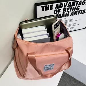 Internal storage view of pink foldable travel bag showing tablets and books capacity