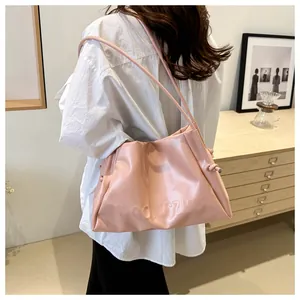 Close-up of pink pleated tote bag with WGONGZHU embossed logo and soft PU texture