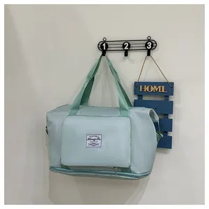 Detail view of mint green waterproof travel bag with expansion zipper on white wall