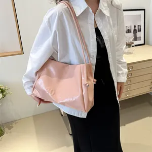 Pink leather tote bag with embossed letters and slim shoulder straps for women