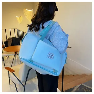 Rear view of a light blue waterproof travel bag showing large capacity and wet-dry compartment