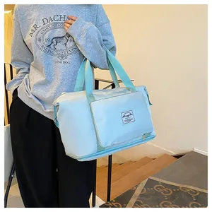 Detail of light blue waterproof nylon travel bag with branded logo and zipper pocket
