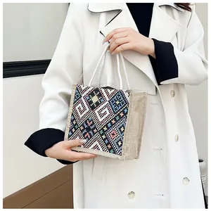 Detailed close-up of a colorful geometric ethnic pattern tote bag with cotton rope handles
