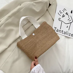 Minimalist summer straw beach tote bag with woven texture and white canvas handles