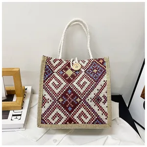 Detail of ethnic geometric pattern woven bag with wooden button and rope handle