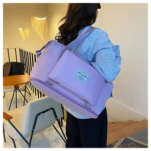 Detail of purple waterproof travel bag with large capacity and reinforced handle straps