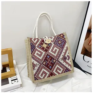 Detailed shot of ethnic geometric woven canvas bag with wood button and rope handles