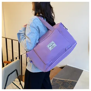 Large capacity purple nylon folding travel bag with adjustable strap and front pocket