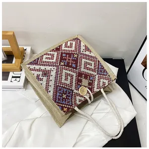 Close-up of geometric woven jute tote with a wooden button and thick rope handles