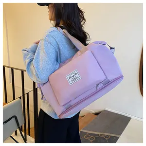 Detail of purple foldable travel bag with dry-wet separation pocket and brand label