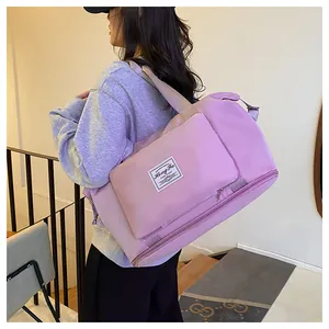 Detail of purple nylon travel bag with front zipper pocket and durable webbing shoulder strap